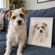 Scruffy terrier beside a white-framed watercolor-style portrait