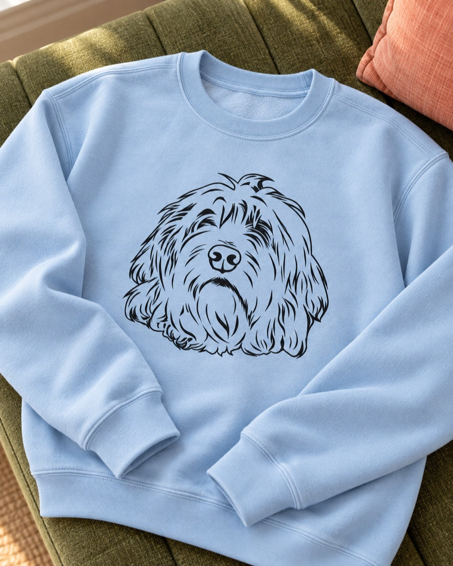 Light-blue crewneck sweatshirt with crisp shaggy-dog line art and visible fabric texture