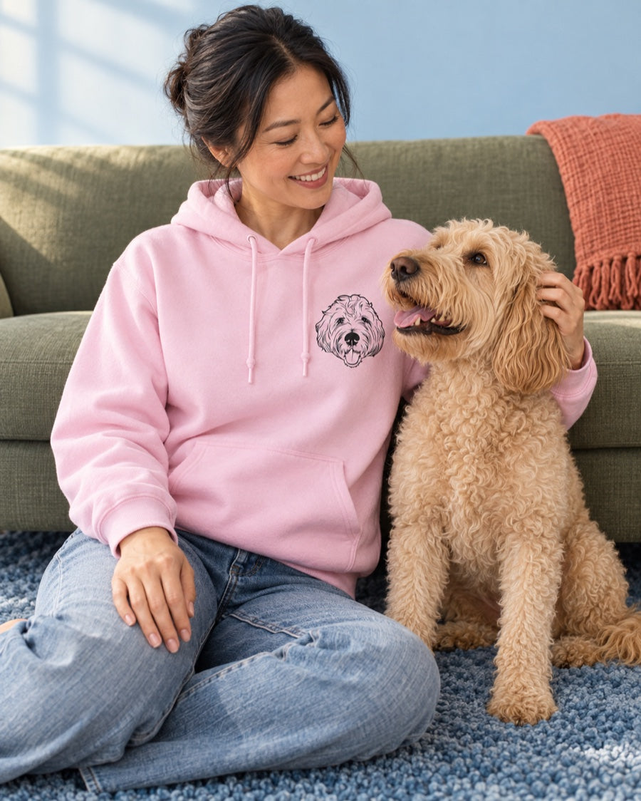 Light-pink hoodie with a curly dog's portrait, worn beside the matching dog