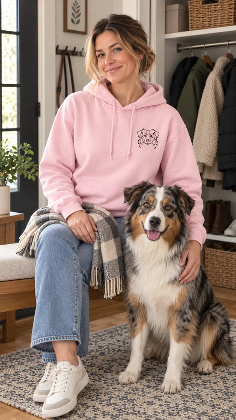 Light pink custom dog hoodie with an Australian shepherd line-art portrait, worn beside an Australian shepherd
